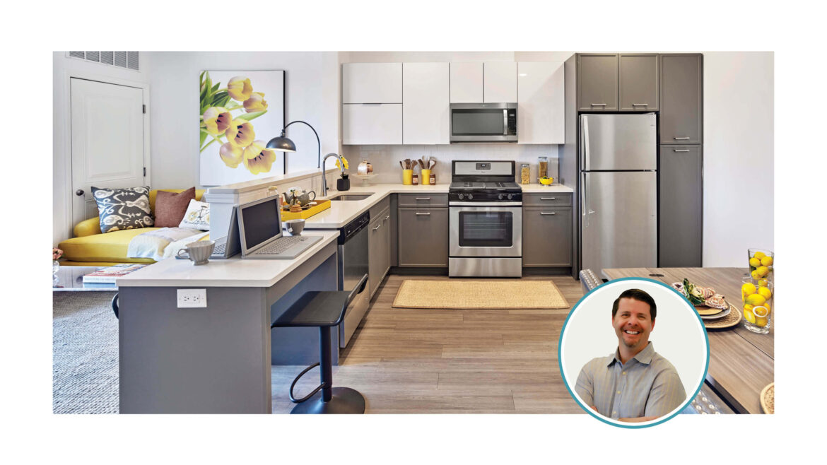 A residential unit with a portion of the counter used for working from home and the author's photo.